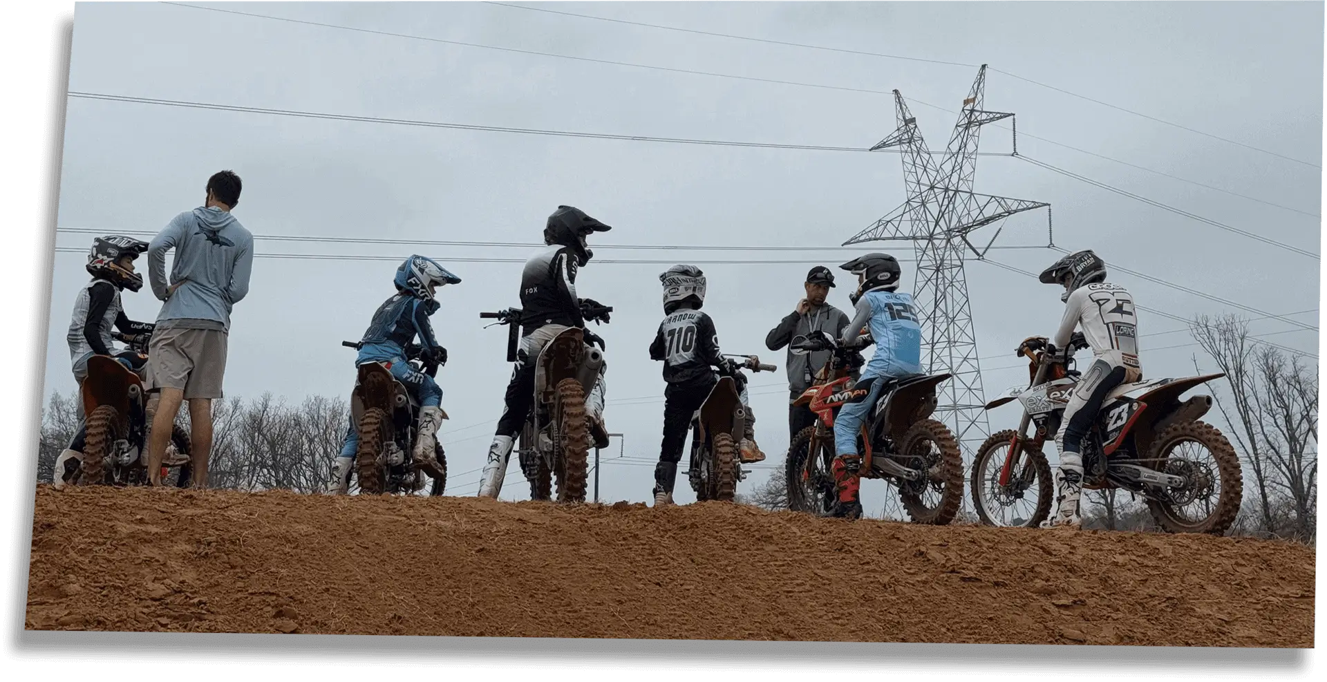 Young riders lined up with coach on ridge